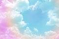 Beautiful pastel color with rainbow shade on white fluffy clouds, colorful blue sky on background, upward view and copy space Royalty Free Stock Photo