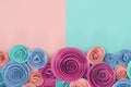 Beautiful pastel paper rose flat lay background with flowers at the bottom and empty copy space above Royalty Free Stock Photo