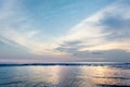 Beautiful Pastel Sunset or Sunrise at Beach with Sun Light Reflection on Sea Water Surface. Cirrus Lenticular and Altocumulus Clou Royalty Free Stock Photo