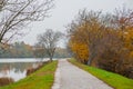 Beautiful path in autumn next to Drava river in Maribor. Fall setting next to a river, lonely cold day