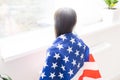 Beautiful patriotic little girl with the American flag held in her outstretched hands Royalty Free Stock Photo