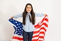 Beautiful patriotic little girl with the American flag held in her outstretched hands Royalty Free Stock Photo