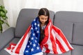 Beautiful patriotic little girl with the American flag held in her outstretched hands Royalty Free Stock Photo