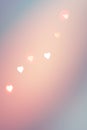 Eautiful pattern from bokeh sparkling garland lights in heart shape of warm pink color on pastel teal blue gradient. Valentine