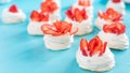 Beautiful pavlova cakes with strawberries on a blue background. Selective focus. Tasty sweet breackfast. Wedding morning. Meringue