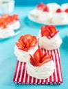 Beautiful pavlova cakes with strawberries on a blue background. Selective focus. Tasty sweet breackfast. Wedding morning. Meringue