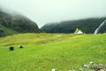 Beautiful peaceful church in Saksun valley next to the waterfall in foggy weather, Faroe Islands, North Europe, hidden gem for Royalty Free Stock Photo