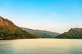 Beautiful and peaceful view of the river flowing through the mountains above the dam in the evening. River and mountain in Khun Royalty Free Stock Photo