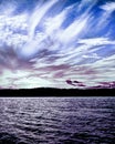 Tranquil peaceful white and lilac cirrus cloud, coastal sunset s Royalty Free Stock Photo