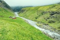 Beautiful peaceful wooden house in Saksun valley with green grass next to the river in foggy weather, Faroe Islands, North Europe Royalty Free Stock Photo