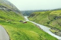 Beautiful peaceful wooden house in Saksun valley with green grass next to the river in foggy weather, Faroe Islands, North Europe Royalty Free Stock Photo