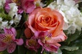 A Close-Up of a Beautiful Bouquet of a Salmon Rose and Adjoining Flowers that Complement the Beautiful Rose