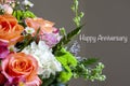 A Close-Up of a Beautiful Bouquet of Roses with surrounding Flowers Wishing a Happy Anniversary