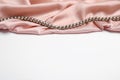 Beautiful pearls and pink silk on white background Royalty Free Stock Photo