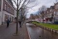 Beautiful pedestrian street in a town with colorful houses. Specific Dutch water channels on the side of the alleys in the city Royalty Free Stock Photo