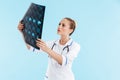 Beautiful blonde woman doctor wearing uniform standing Royalty Free Stock Photo