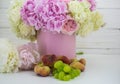 Beautiful peonies in the pink box with fruits on wooden background Royalty Free Stock Photo
