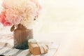 Beautiful peonies in vase and gift box on rustic wooden table in sunny morning light with space for text. Happy mothers day Royalty Free Stock Photo