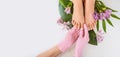 Beautiful perfect female skin legs feet top view with tropical flowers and green palm leaf. Nail polish, care and clean, spa Royalty Free Stock Photo