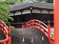 Beautiful red bridge in the garden of a Japanese Shinto shrine Royalty Free Stock Photo