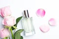 Beautiful perfume bottles and rose on white