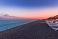 Perissa, beach at sunset, Santorini, Greece with beautiful beach huts, blue sky and clouds