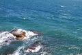 Beautiful petrous bright blue sea beach with huge stones on a summer day, natural landscape photo