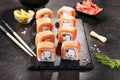 Beautiful Philadelphia Sushi Rolls Set with Salmon and Cream Cheese and Cuccumber on Black Slate Plate Close Up. Uramaki, Nori Mak Royalty Free Stock Photo