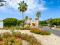 Beautiful image of flower bed in front of old church in spanish colonial style