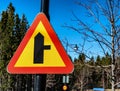 Beautiful photo of fresh new intersection with minor side-road on the right sign. It mounted on black metal pole, blurred