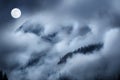 Beautiful Blue Moon Rises over layers of fog and clouds in the Colorado Rocky Mountains Royalty Free Stock Photo