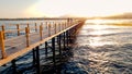 Beautiful image of long wooden pier in the ea. Amazing sunset over the bridge in ocean