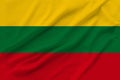 Beautiful photo of the national flag of Lithuania on delicate shiny silk with soft draperies, the concept of state power, country