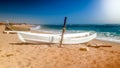 Beautiful photo of old white wooden boat lying on the sea shore. Fesherman boat on the beach Royalty Free Stock Photo