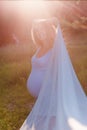 Beautiful photo pregnant woman in white clothes