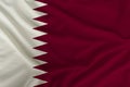 Beautiful photo of the Qatar national flag on delicate shiny silk with soft draperies, the concept of state power, country life,