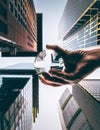 Look up at a street crossing between skyscrapers and offices. a hand holds a lens ball Royalty Free Stock Photo