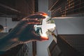 Look up at a street crossing between skyscrapers and offices. a hand holds a lens ball Royalty Free Stock Photo