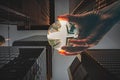 Look up at a street crossing between skyscrapers and offices. a hand holds a lens ball Royalty Free Stock Photo