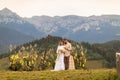 beautiful photograph captures the tender embrace of a couple at their humanist wedding ceremony. The bride is holding a lovely