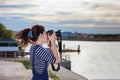 Beautiful photographer taking a photo near Chao Phraya River in