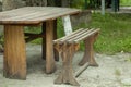 Beautiful picnic area with wooden table and blooming rhododendrons,