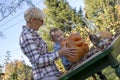 Beautiful picture of a grandmother with her grandchild making a Halloween pumpkin in the park