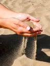 Beautiful picture of a woman`s hands holding and pouring sand