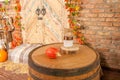 Autumn yellow leaves, pumpkins, autumn, barrel, lamp, straw, wooden door on the background.