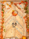 Autumn yellow leaves, pumpkins, autumn, straw, wooden door on the background.