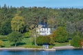 Beautiful picturesque private waterfront mansion in Stockholm skargard archipelago at early autumn sunny morning Royalty Free Stock Photo