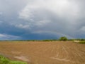 A beautiful picturesque scenic landscape of arable agricultural land after the rain and a colorful rainbow in the background Royalty Free Stock Photo