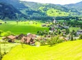 Beautiful, picturesque, stunning summer day view of Lungern Village surrounding its Pfarrkirche Catholic Church from train window Royalty Free Stock Photo