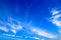 Beautiful picturesque white feather clouds on the blue sky with a young moon , magic romantic background Royalty Free Stock Photo